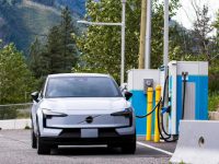Electric vehicle at a BC Hydro charging station in Lytton, B.C. with mountains and trees in the background.